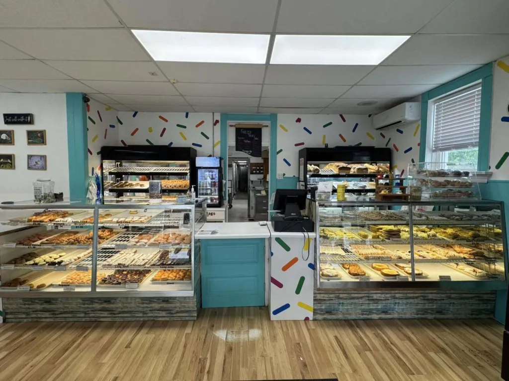 Inside The Worn Whisk Bakery — display cases full of fresh donuts, pastries, and breads in New Baden, IL